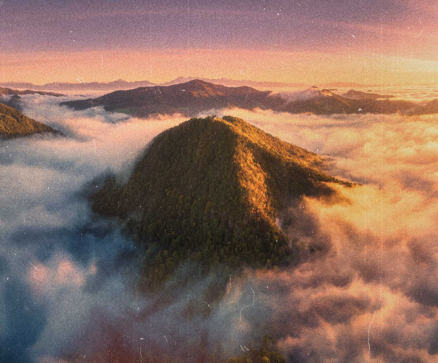 a winding river as a sun rises over a valley